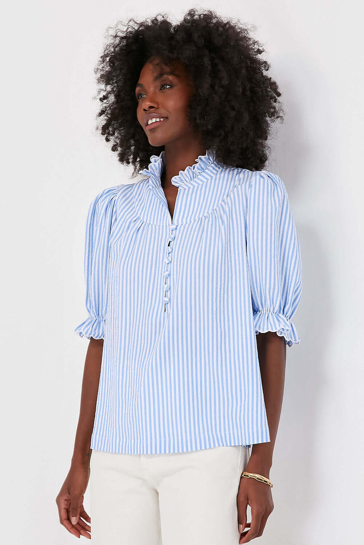 Women wearing a blue striped top with short sleeves.