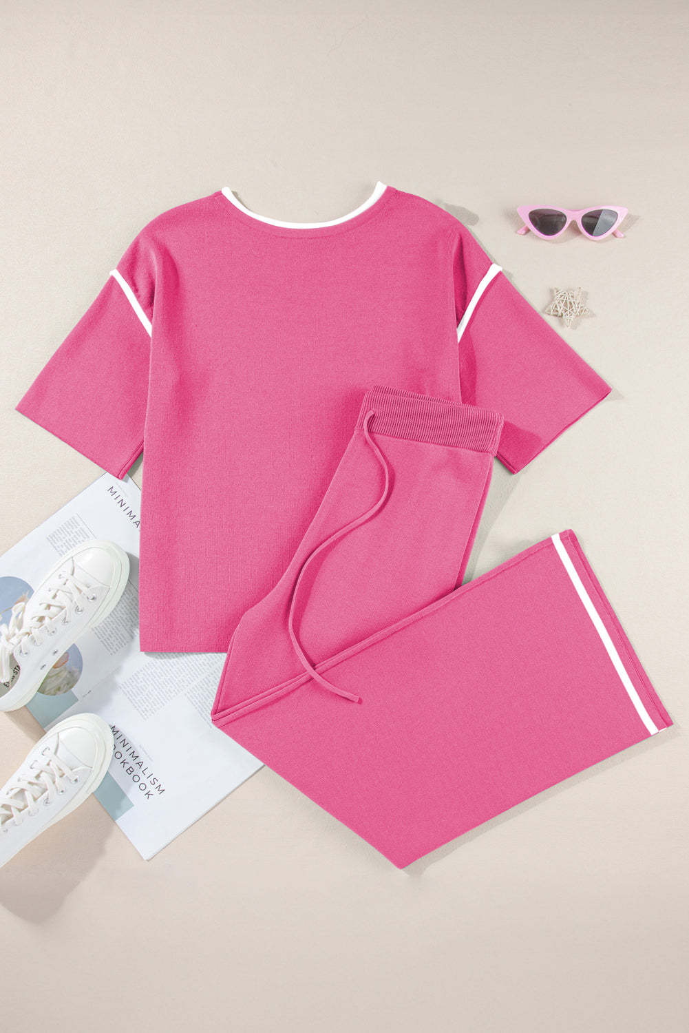 Pink outfit with shorts on a light brown background