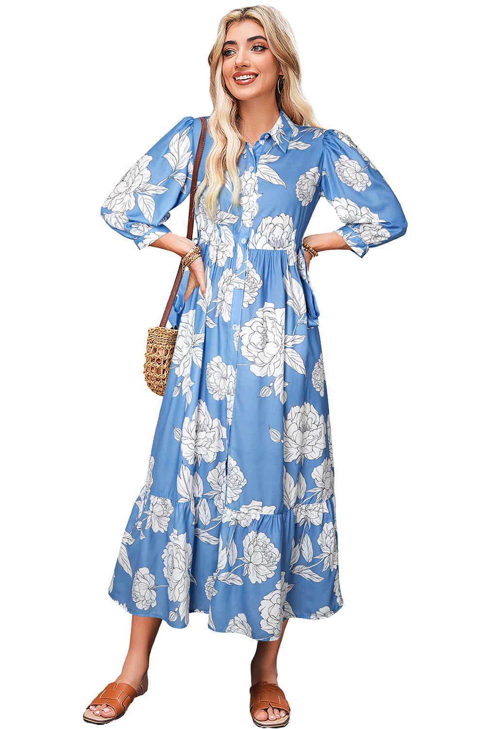 Woman wearing a blue floral dress with a white background