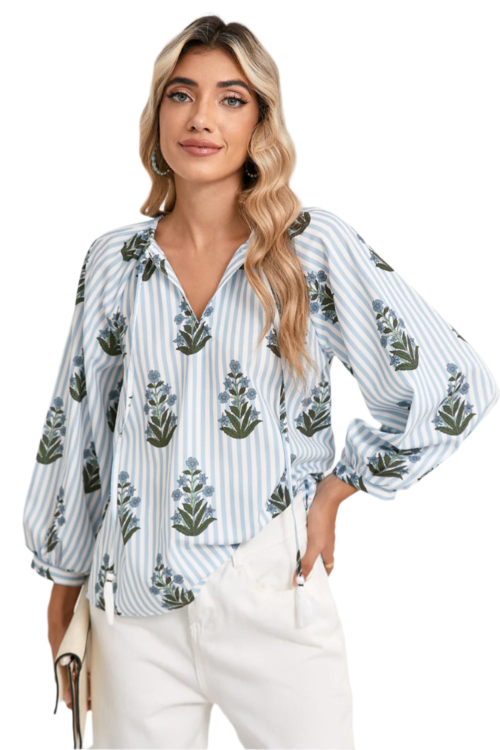 Front view of a blue floral striped blouse with long sleeves, perfect for spring and summer, worn by a model paired with white pants from Catherine Martin store.