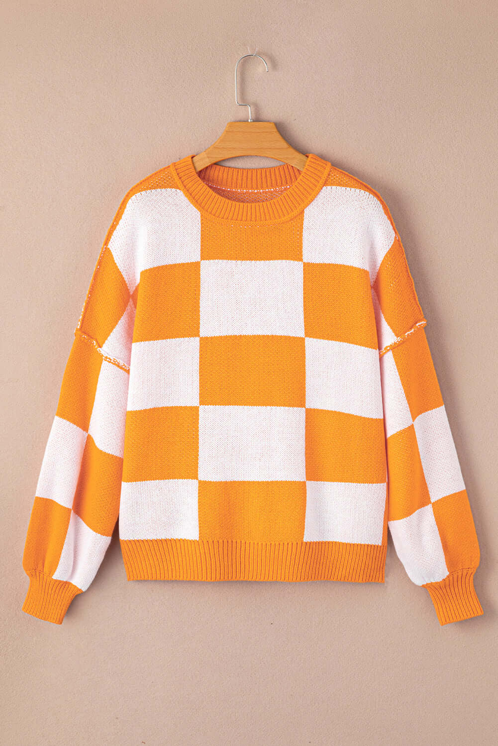 Women's Casual Check Knitted Jumper - Orange. Front view, on a hanger.