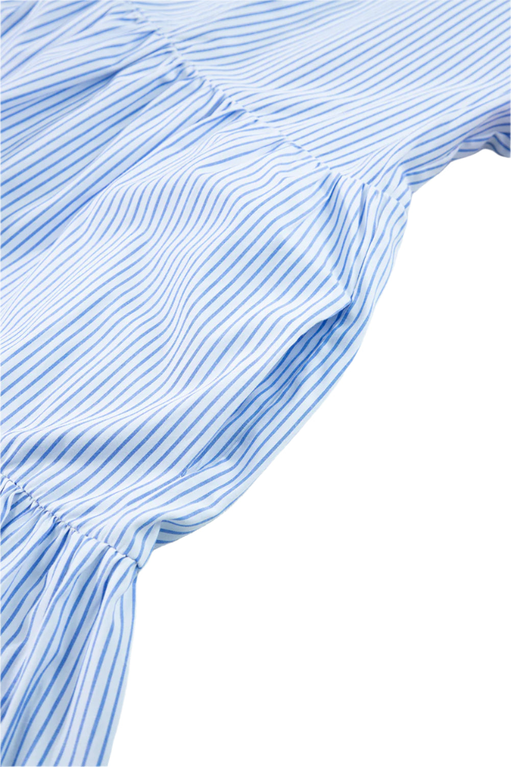 Close-up of pocket on blue striped tiered mini dress with floral red and pink puff sleeves.