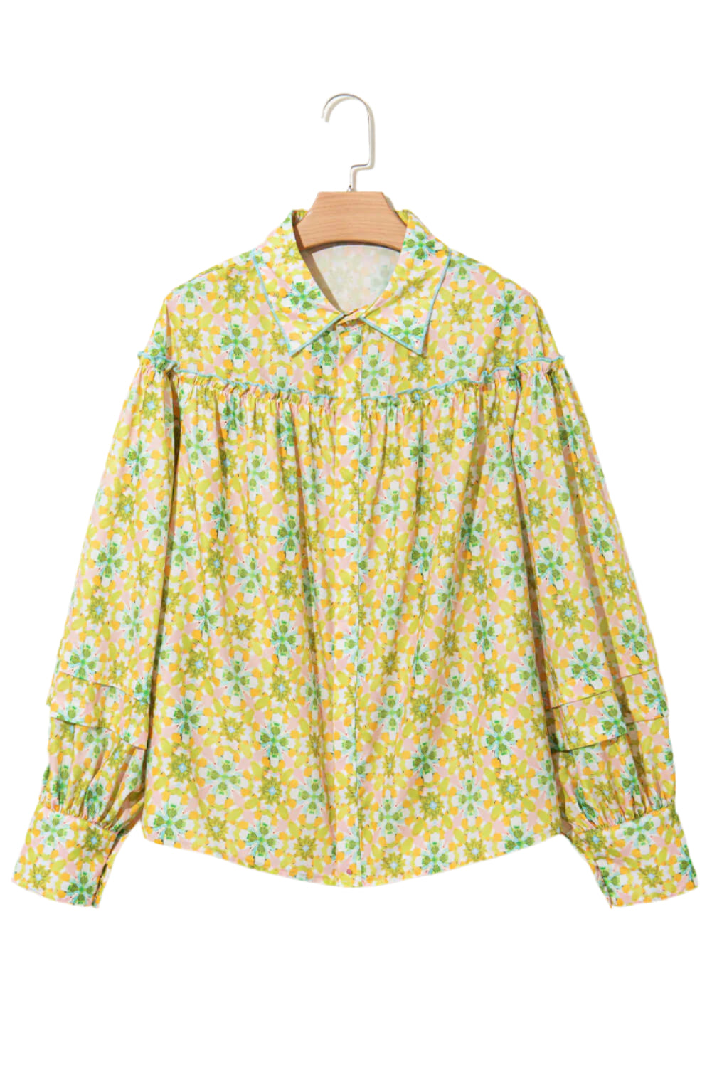 Front view of a green and yellow floral blouse with balloon sleeves on a hanger.