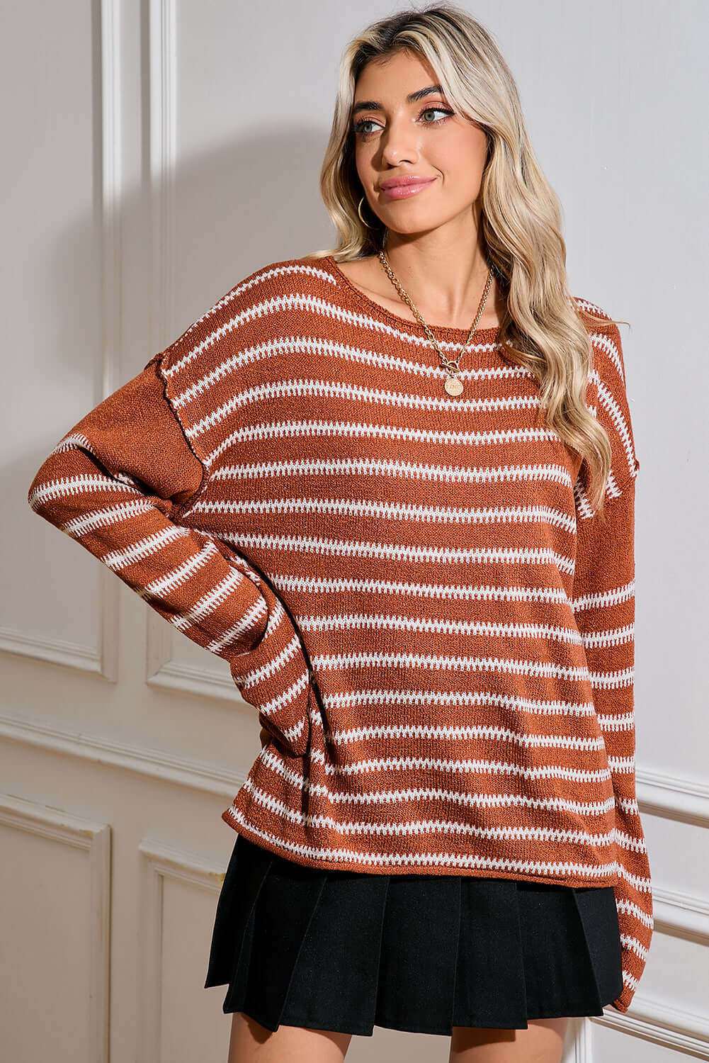 Woman styling the jumper for a cosy, everyday outfit with a modern touch.