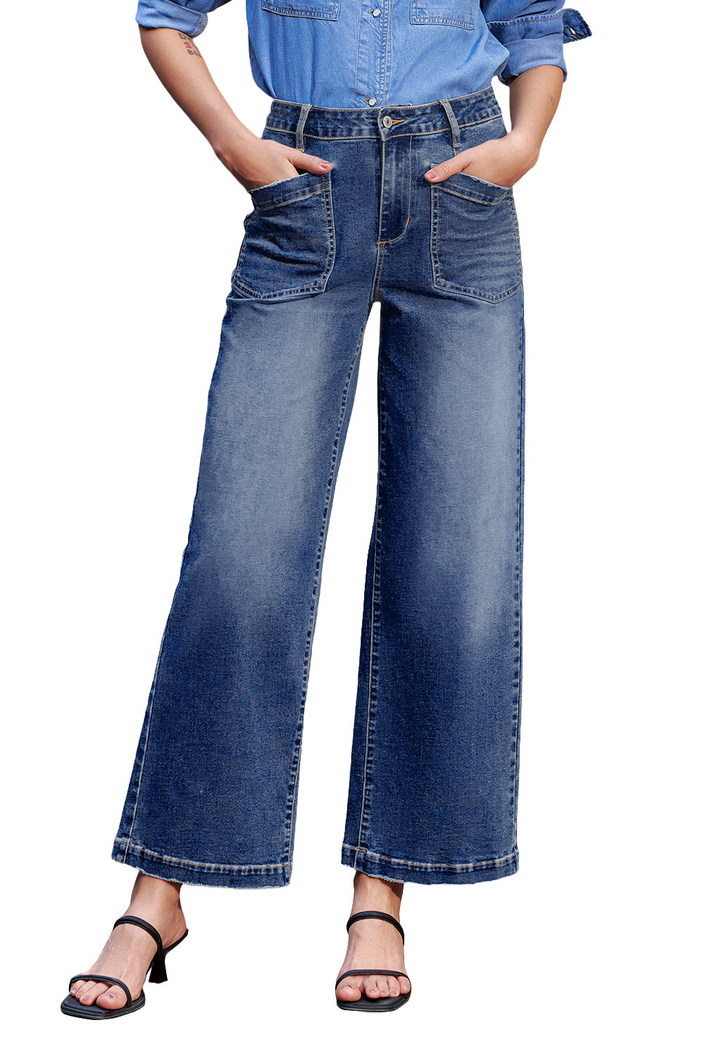 Person wearing blue jeans and a denim shirt on a white background