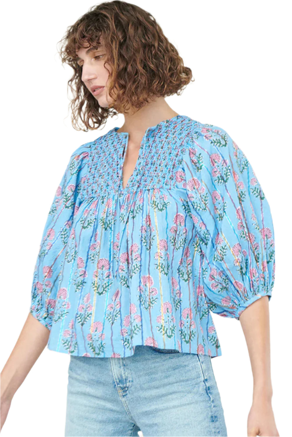 Model standing in a light blue striped floral blouse with half sleeves.