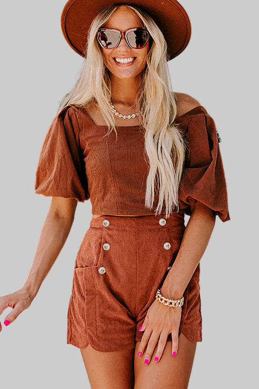 Woman wearing a brown outfit with a hat and sunglasses on a plain background