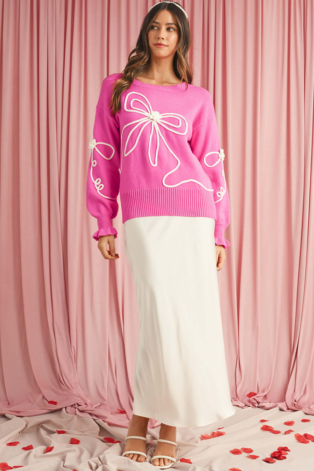 Model wearing pink jumper with bow, Australian style.