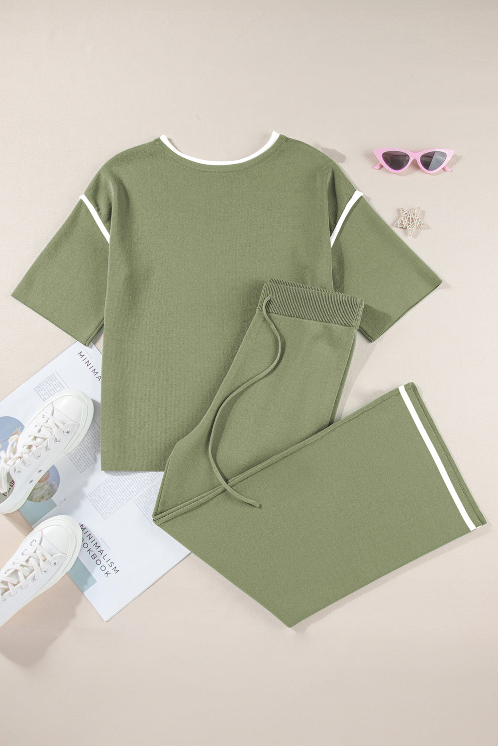 Green outfit with matching pants on a light gray background