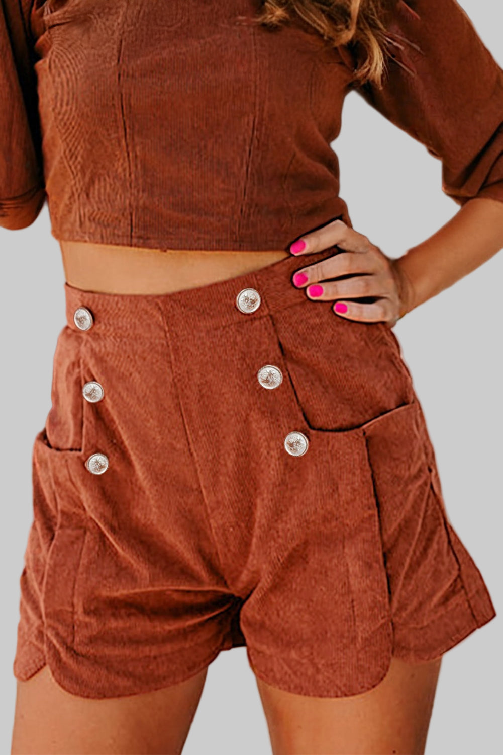 Brown corduroy outfit with button details on a blurred background