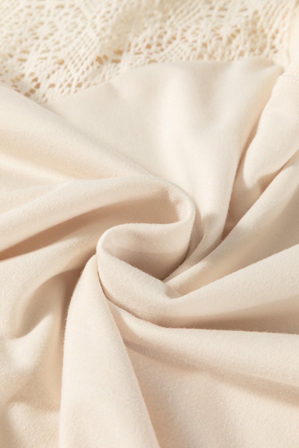 Close-up of beige fabric with a textured background