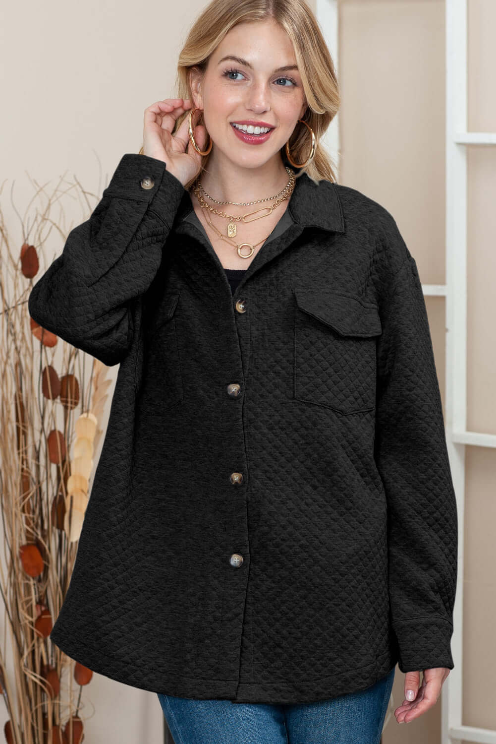 Woman wearing a longline quilted jacket with a stylish lattice texture.