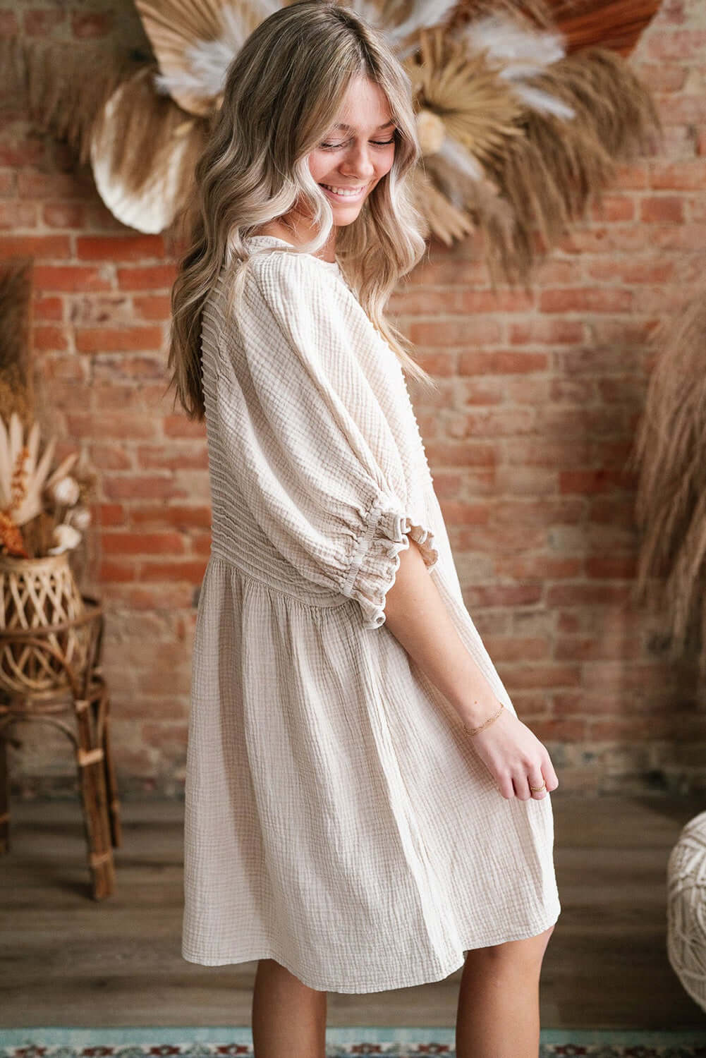 Cute Neutral Tone Loose Dress with Sleeves. Side view.