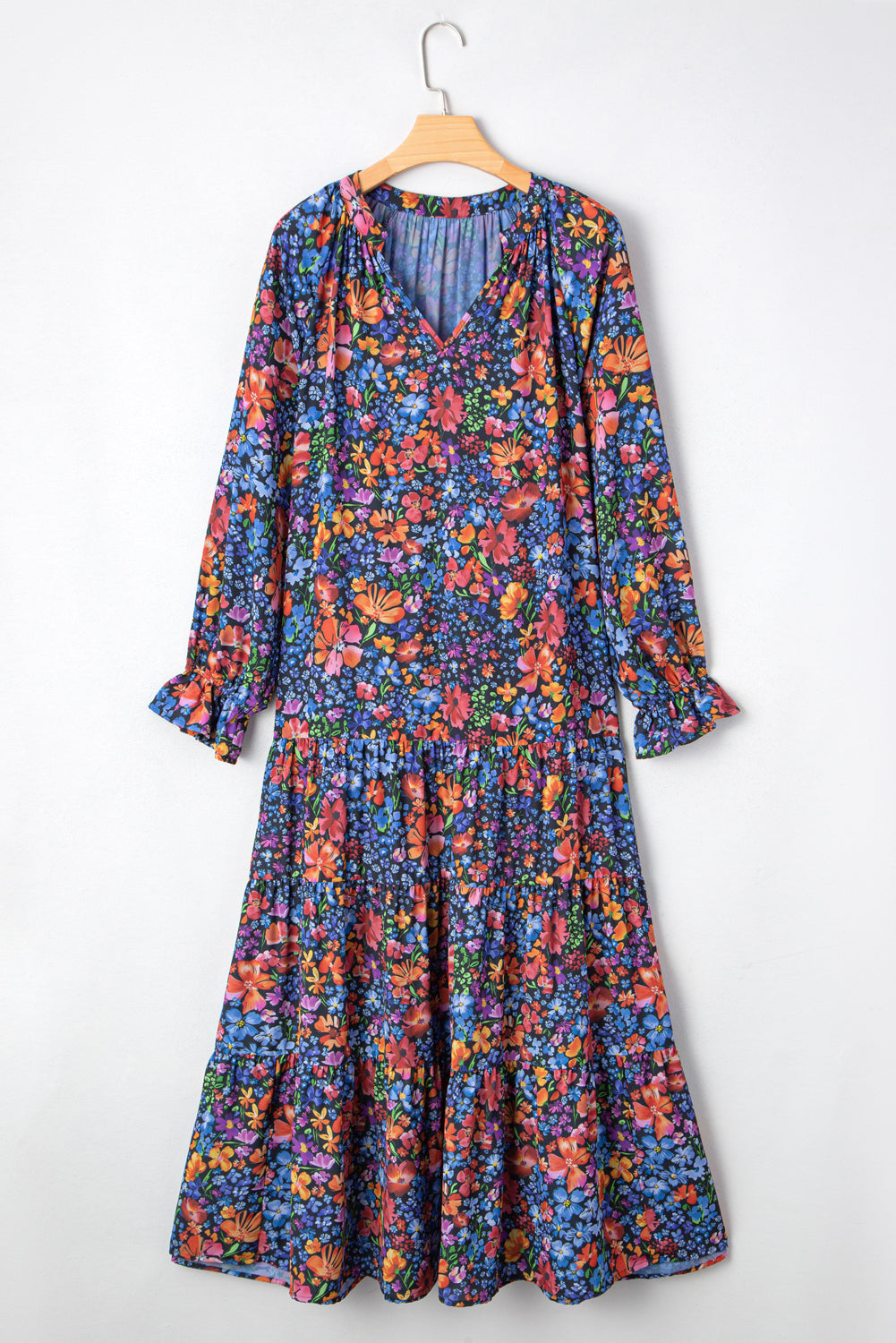 Floral dress on a hanger against a white background