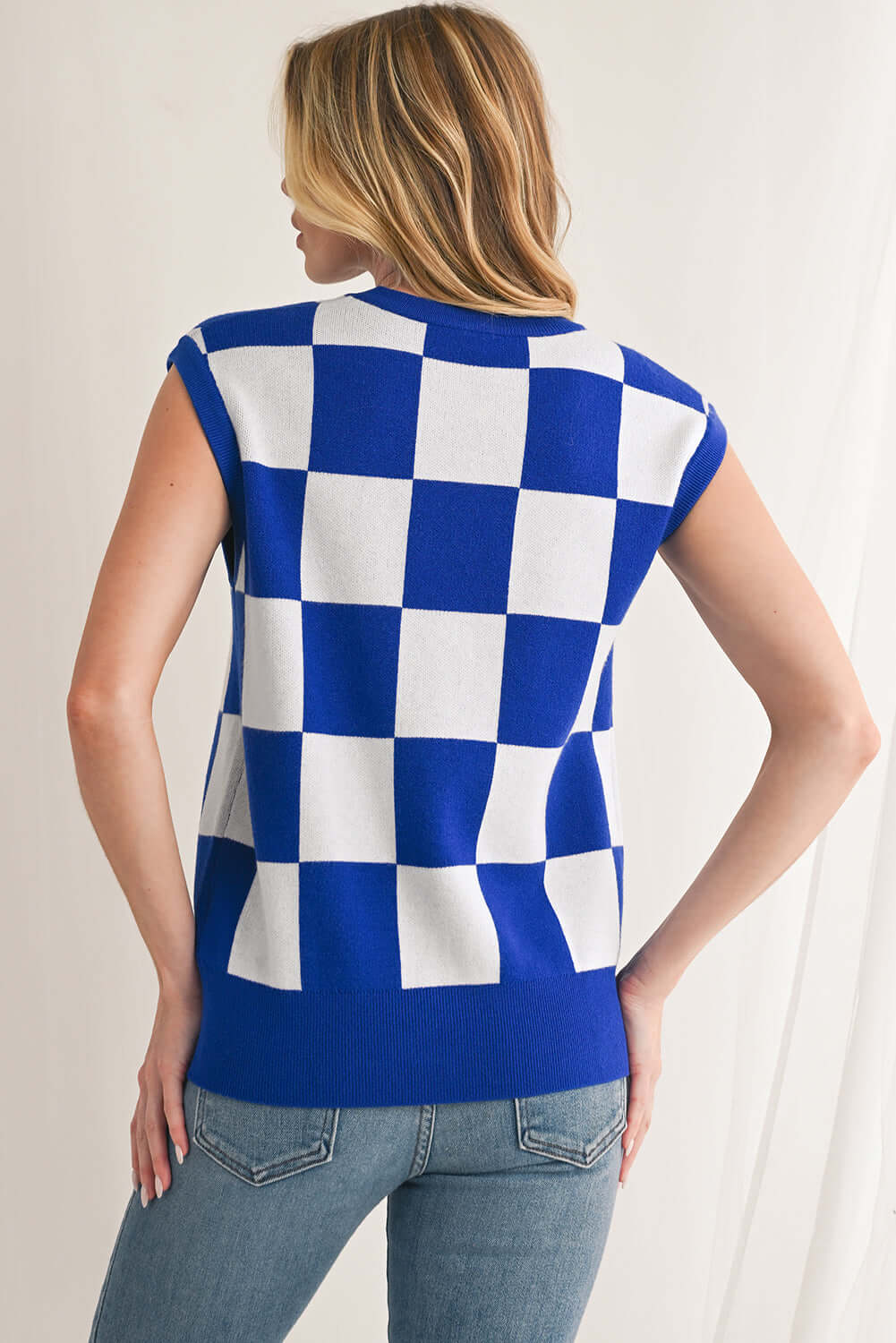 Back view of a blue and white check knit top, ideal for layering.