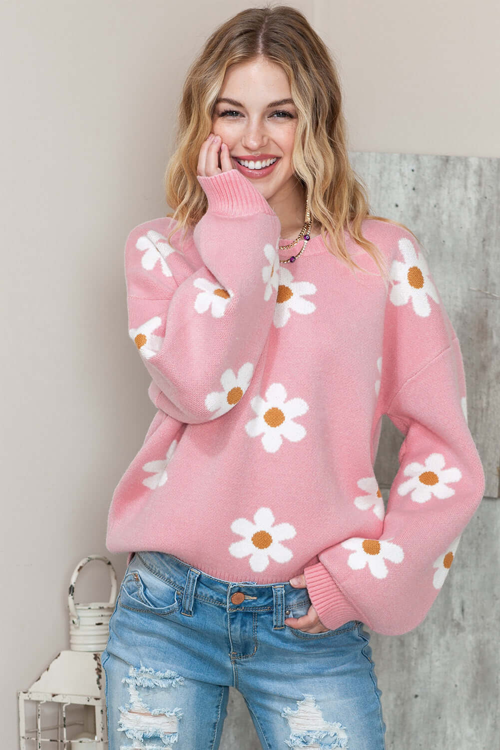Pink floral knit jumper for women on a smiling model.