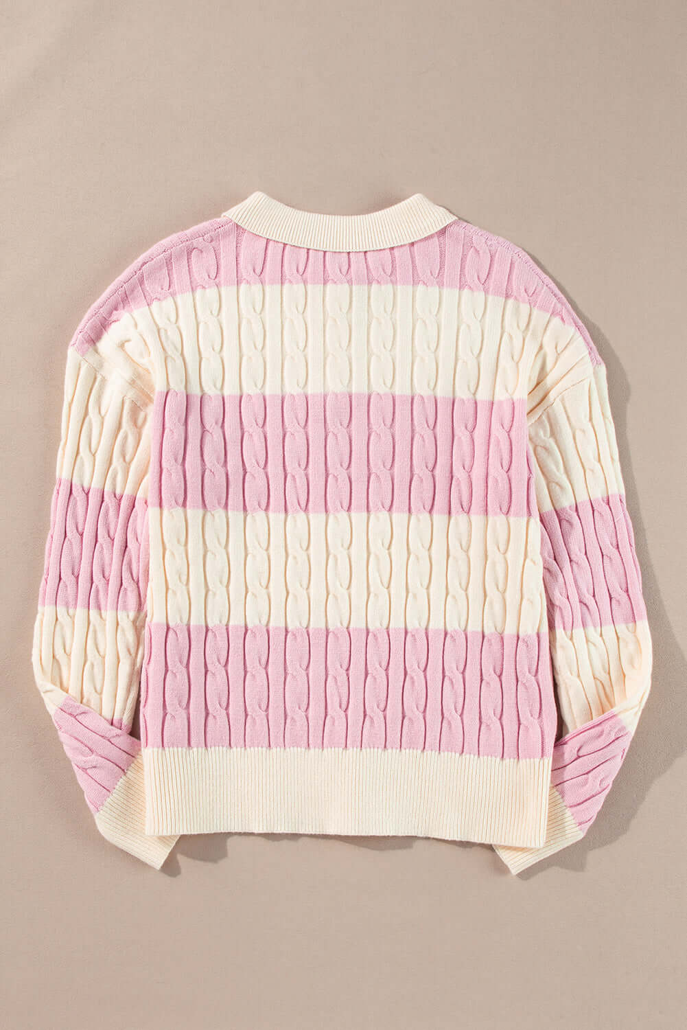Flat lay of cable knit sweater – perfect layering piece for cooler days. Back view.