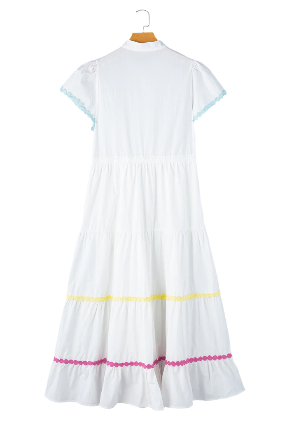 Full back view of a white tiered shirt dress with short sleeves and a waist tie displayed on a hanger, showcasing its elegant design.