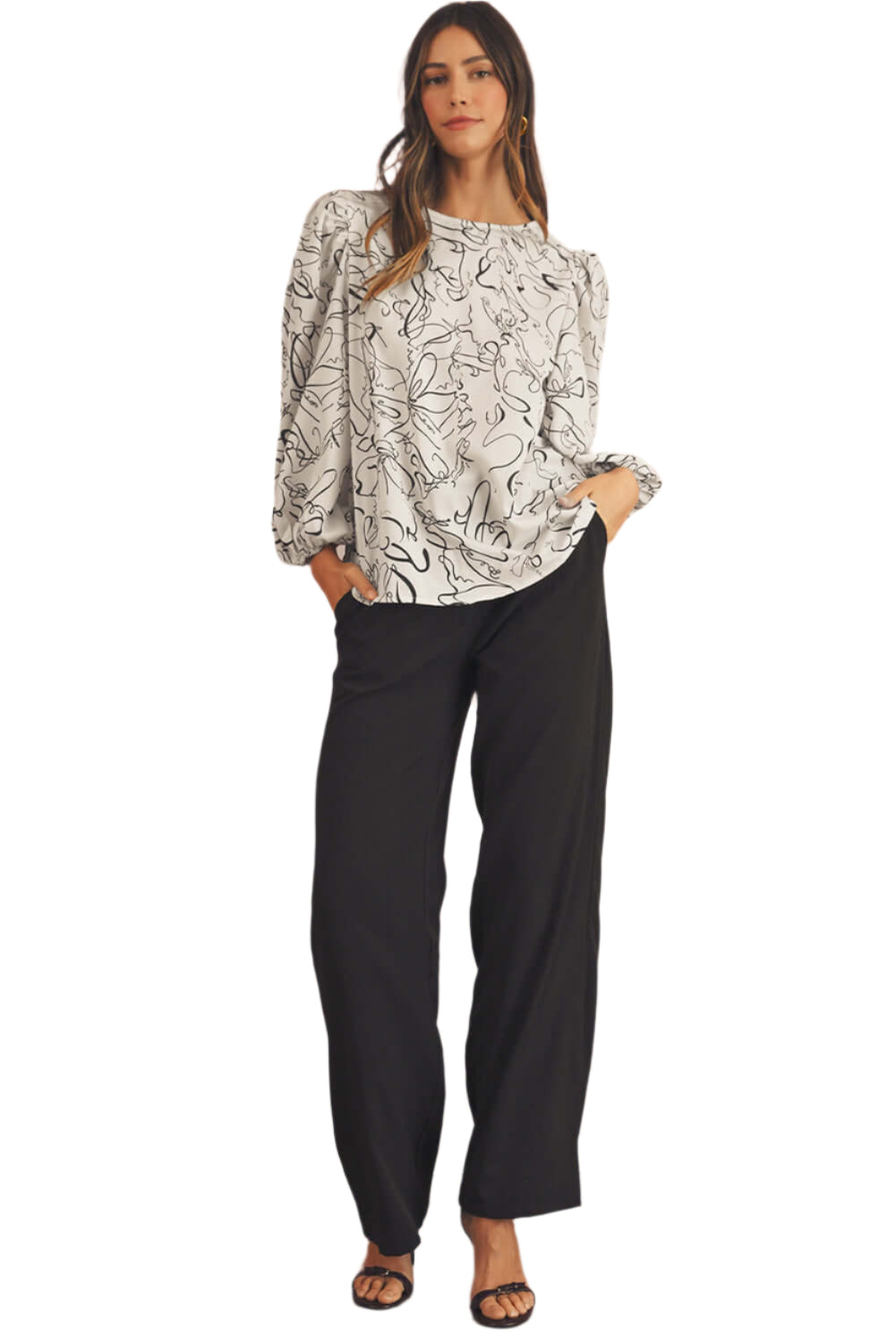 A full view of the black and beige blouse, featuring a crew neck and balloon sleeves. Perfect for both parties and casual wear.