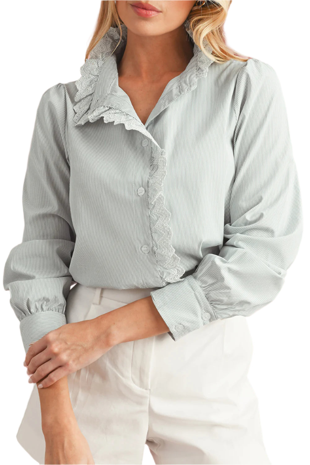Front view of model wearing a blue striped shirt with lace trim details and long sleeves.