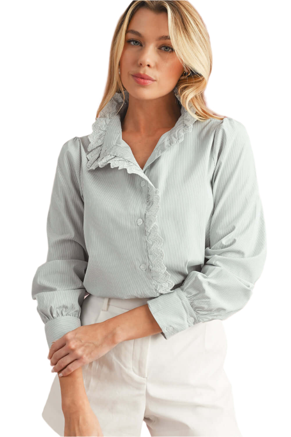 Front view of model wearing a blue striped shirt with lace trim details and long sleeves, with her left hand resting on her right arm.