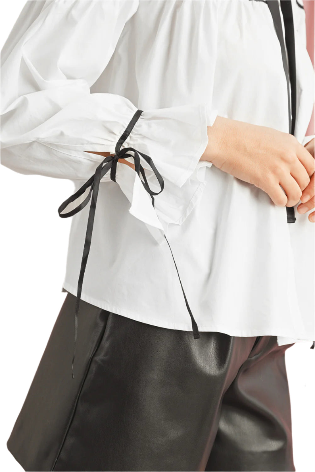 Close-up side view of a white bowknot blouse with long sleeves, lightweight fabric, ideal for spring and summer wear.