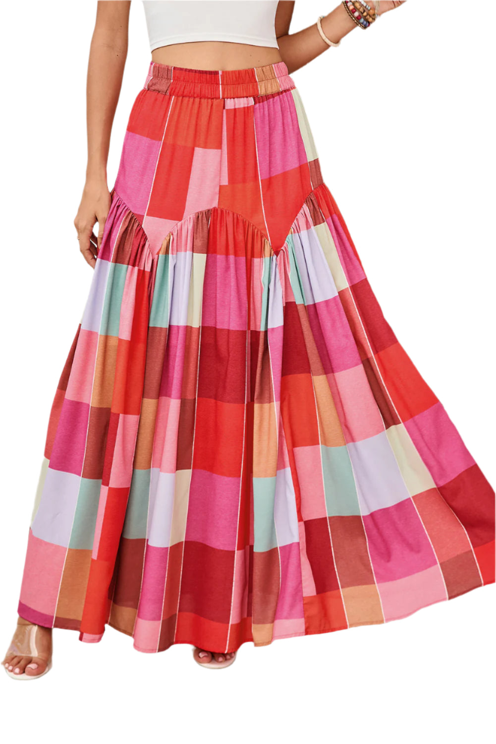 Front view of a red plaid maxi skirt worn by a model indoors, perfect for spring and summer occasions.
