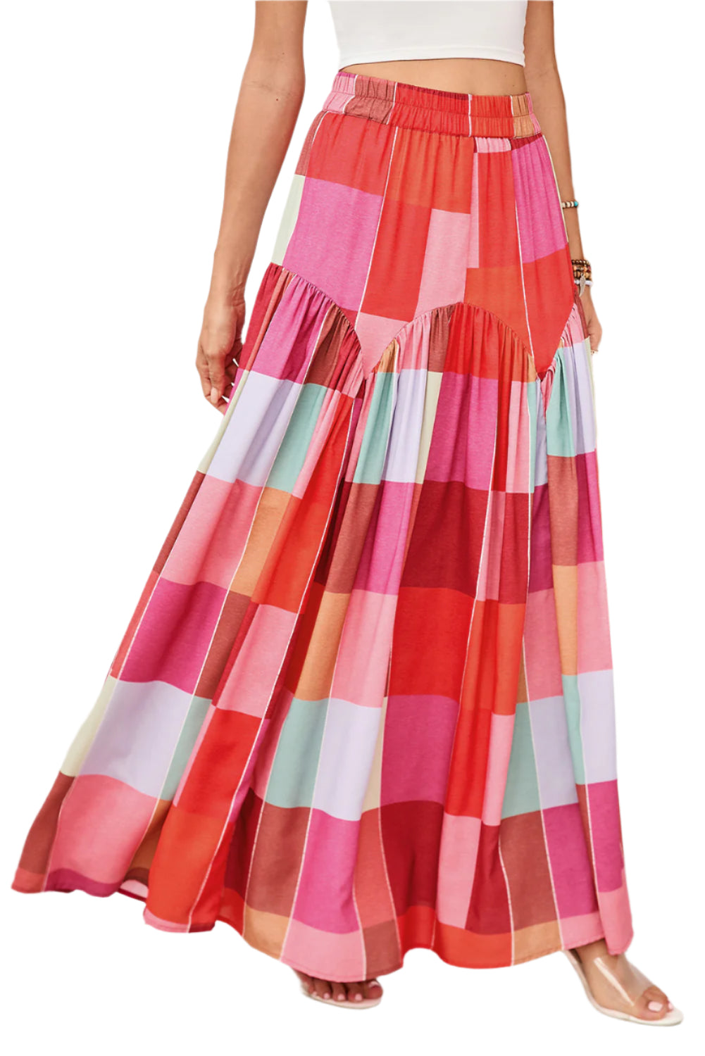 Front view of a red plaid maxi skirt on a model, perfect for spring and summer occasions, featuring a stylish and versatile design.