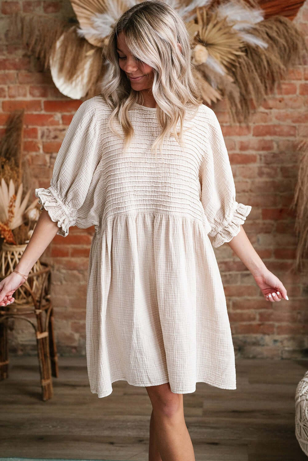 Cute Neutral Tone Loose Dress with Sleeves. Full front view. Indoor setting.