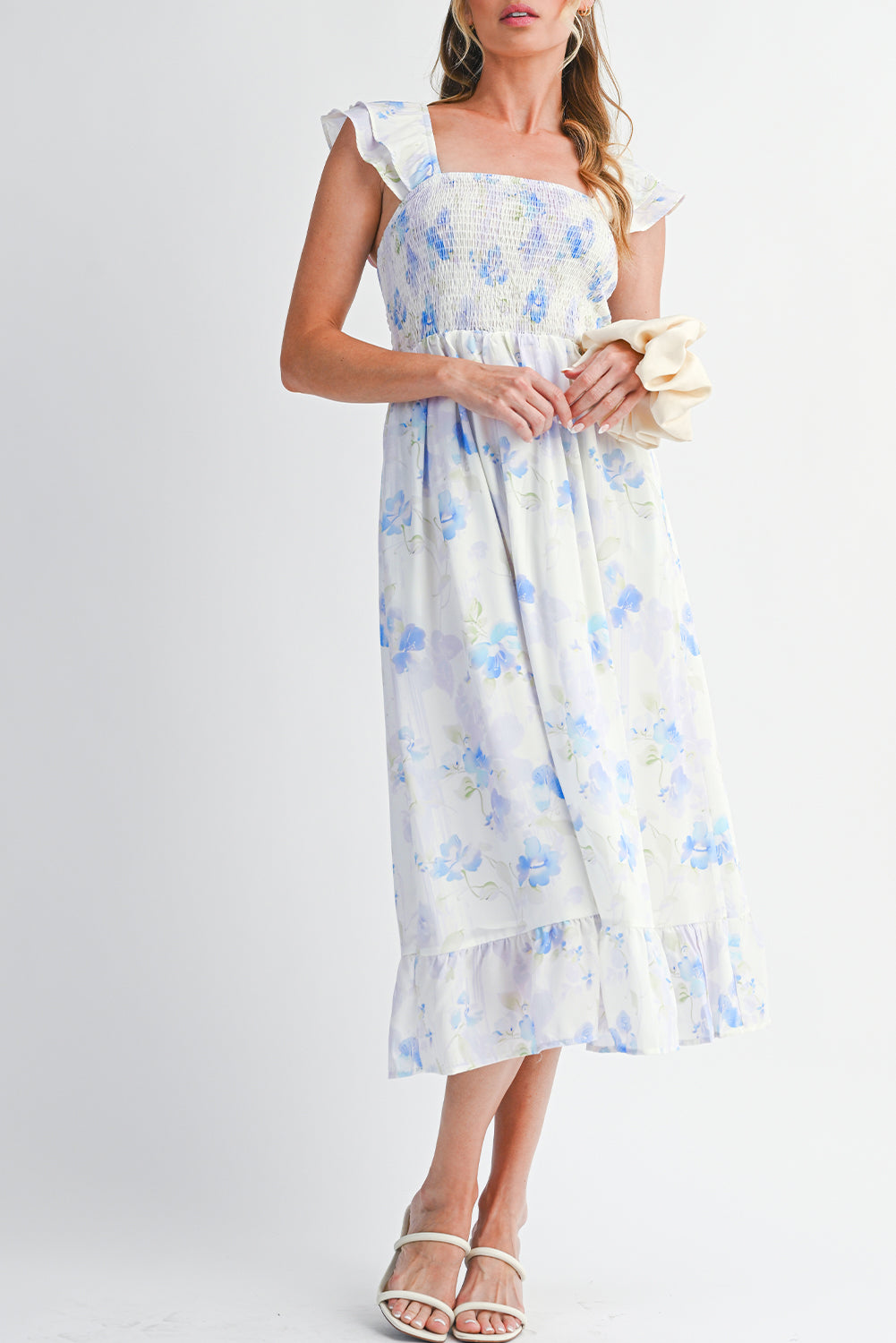Woman wearing a floral dress with a plain background
