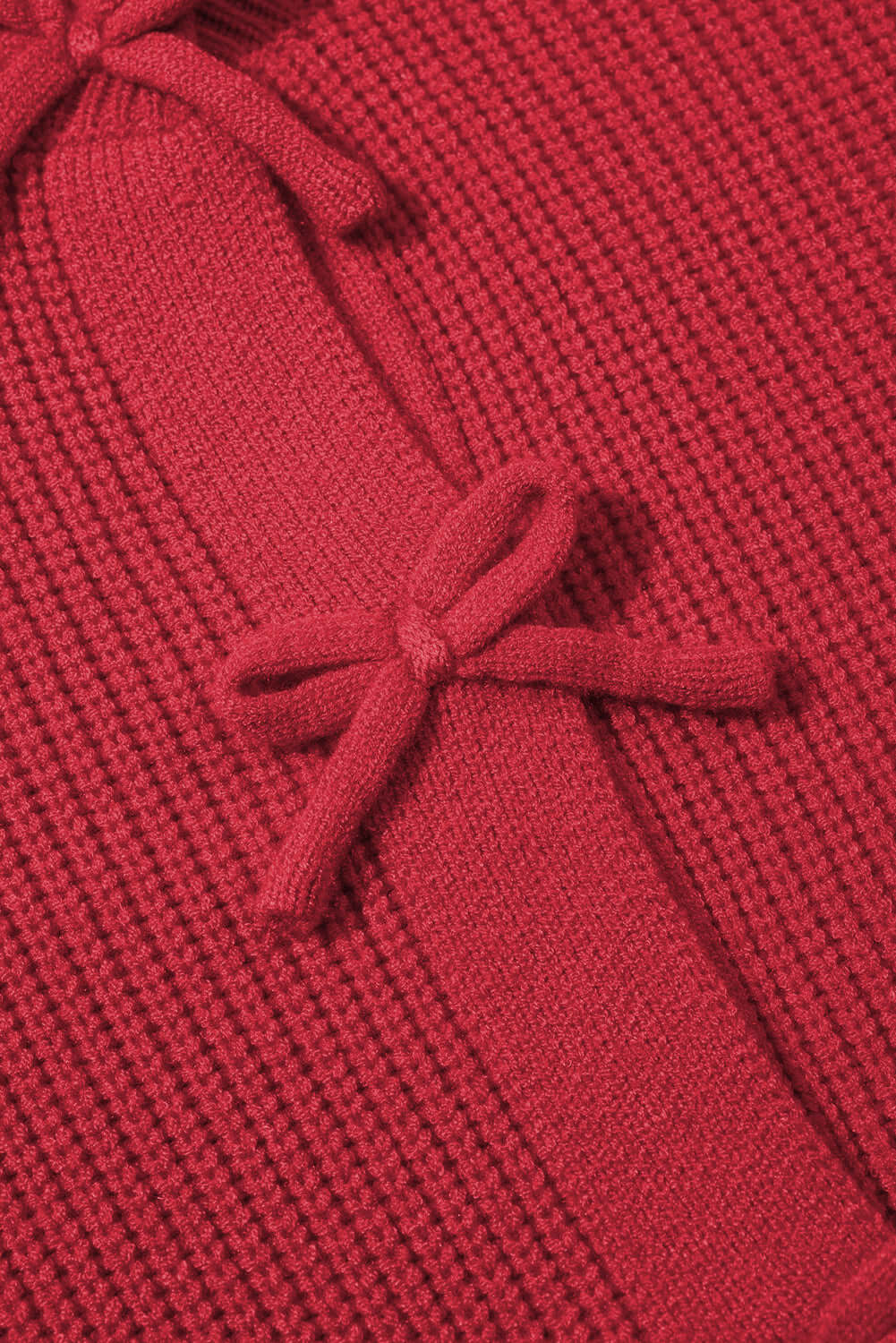 Ladies Cardigan with Bow Fronts. Red colour. Fabric view.