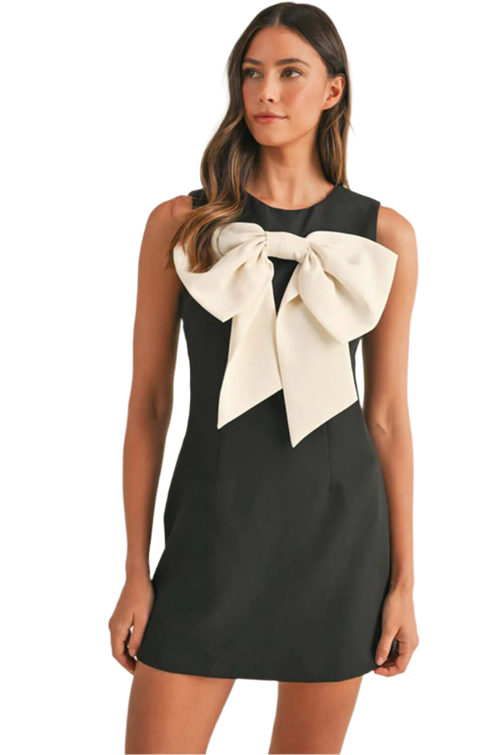Woman is wearing a black sleeveless mini dress with bow front, half view, ideal for summer wedding and party occasions.