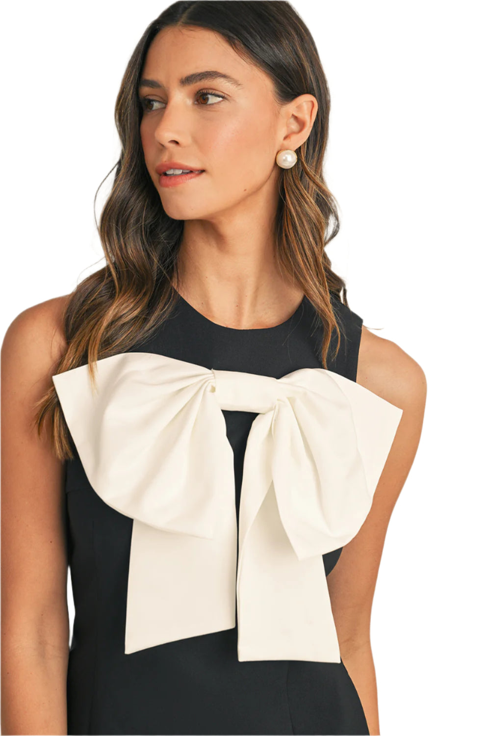 Focus view on a black mini dress with bow tie at front.
