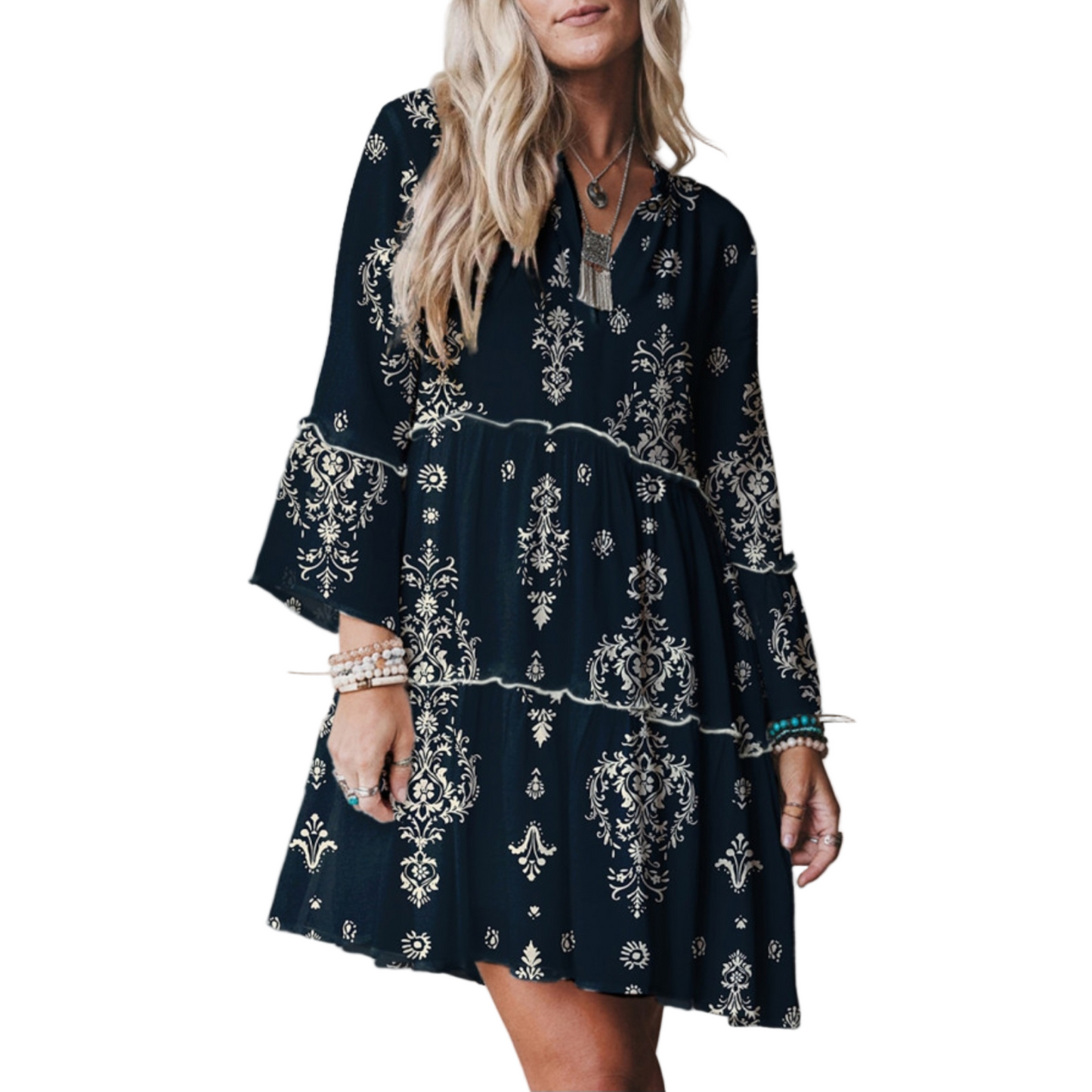 Navy blue dress with white patterns worn by a person on a plain background