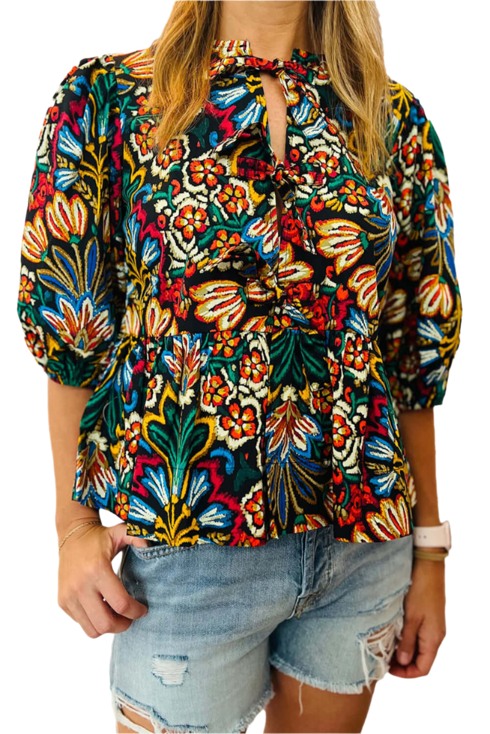 Boho floral blouse with vibrant print, puff sleeves, and a tie-front neckline, shown on a white background.