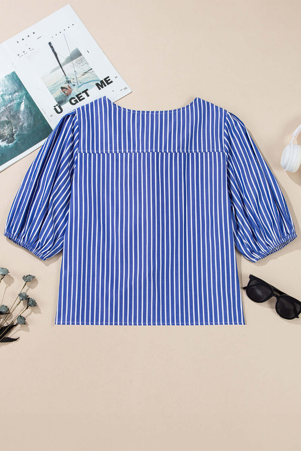 Back view of a bow tie blue stripe with puff sleeves, ideal for casual occasions.