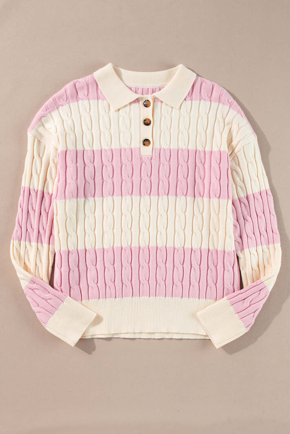 Flat lay of cable knit sweater – perfect layering piece for cooler days. Front view.
