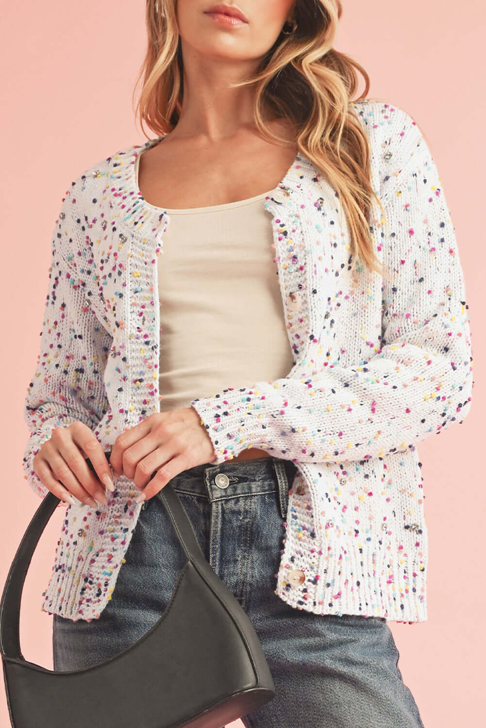 Elegant white knit cardigan with a relaxed fit and shimmering accents.