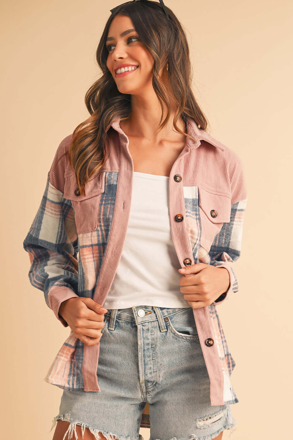 Model layering the pink plaid shirt over a basic tee for a casual, laid-back vibe.
