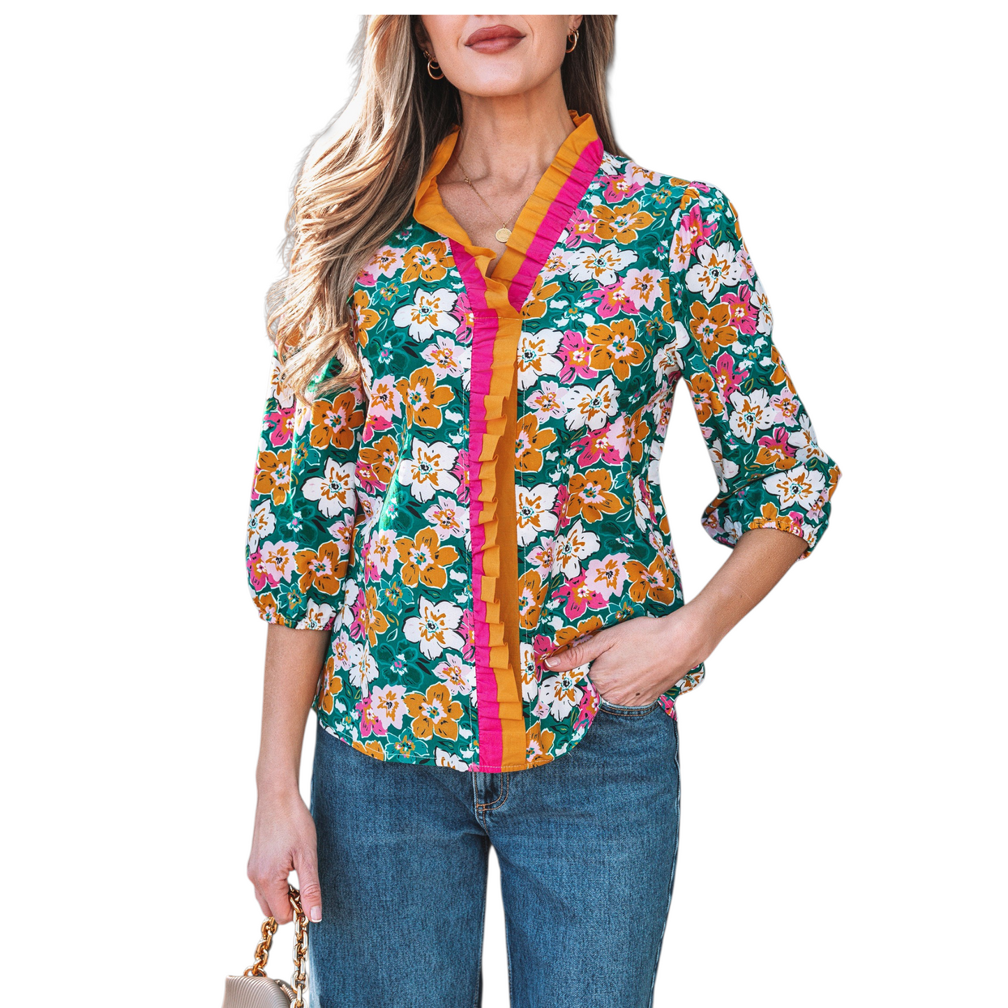 A woman wearing an emerald green floral V-neck blouse featuring distinctive magenta and ochre contrast frilled trim along the neckline and 3/4 length sleeves.