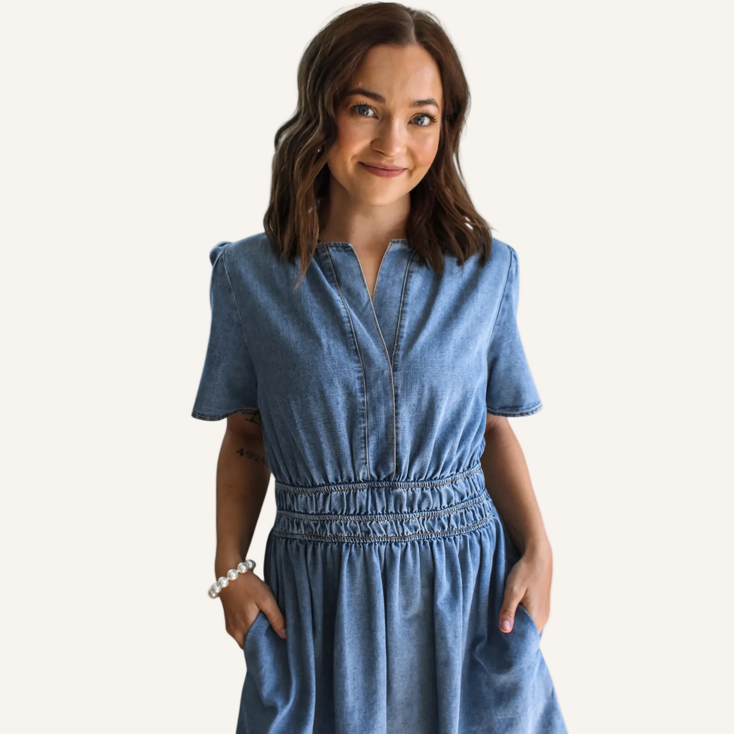 Woman wearing a blue dress on a neutral background