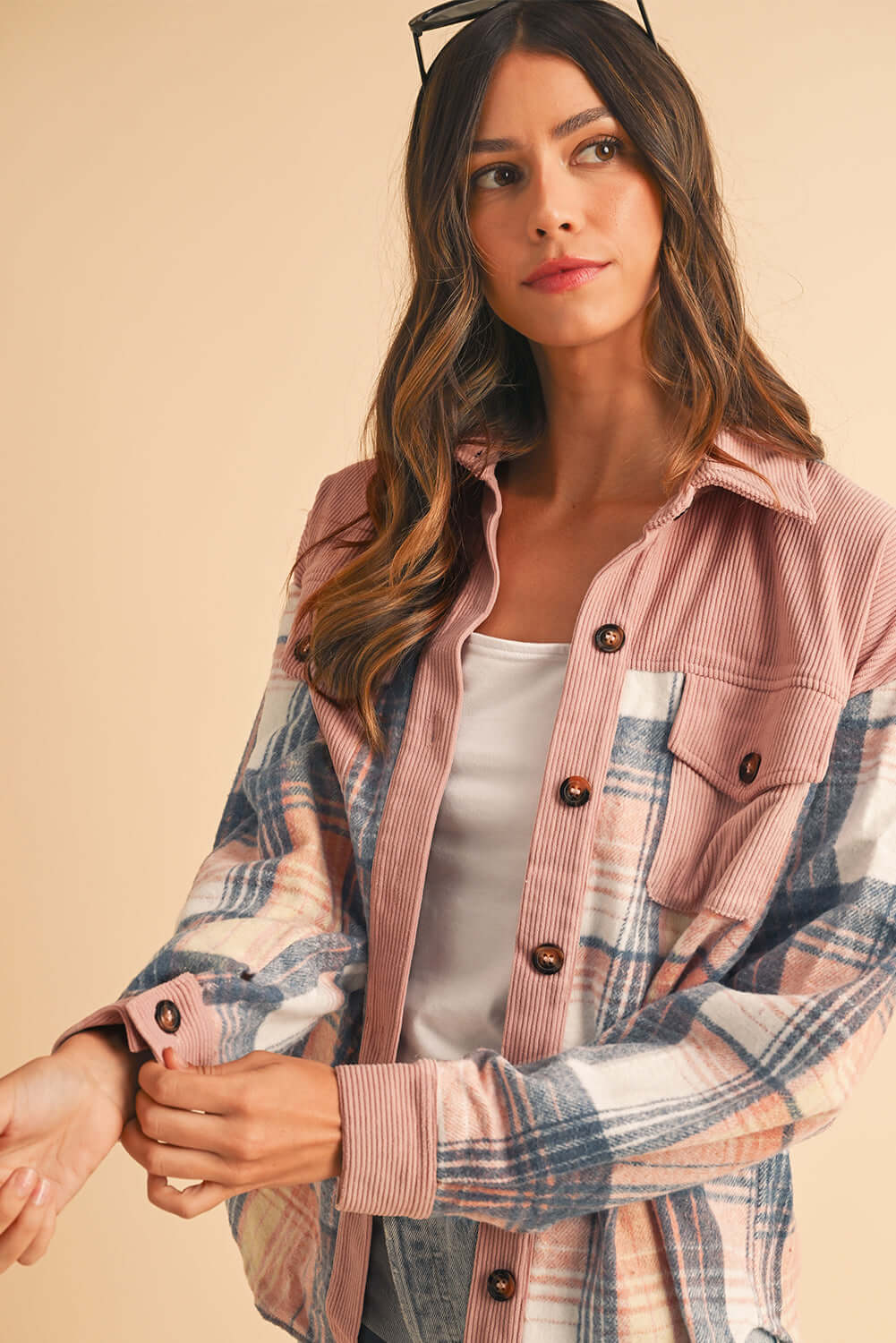 Model layering the pink plaid shirt over a basic tee for a casual, laid-back vibe.