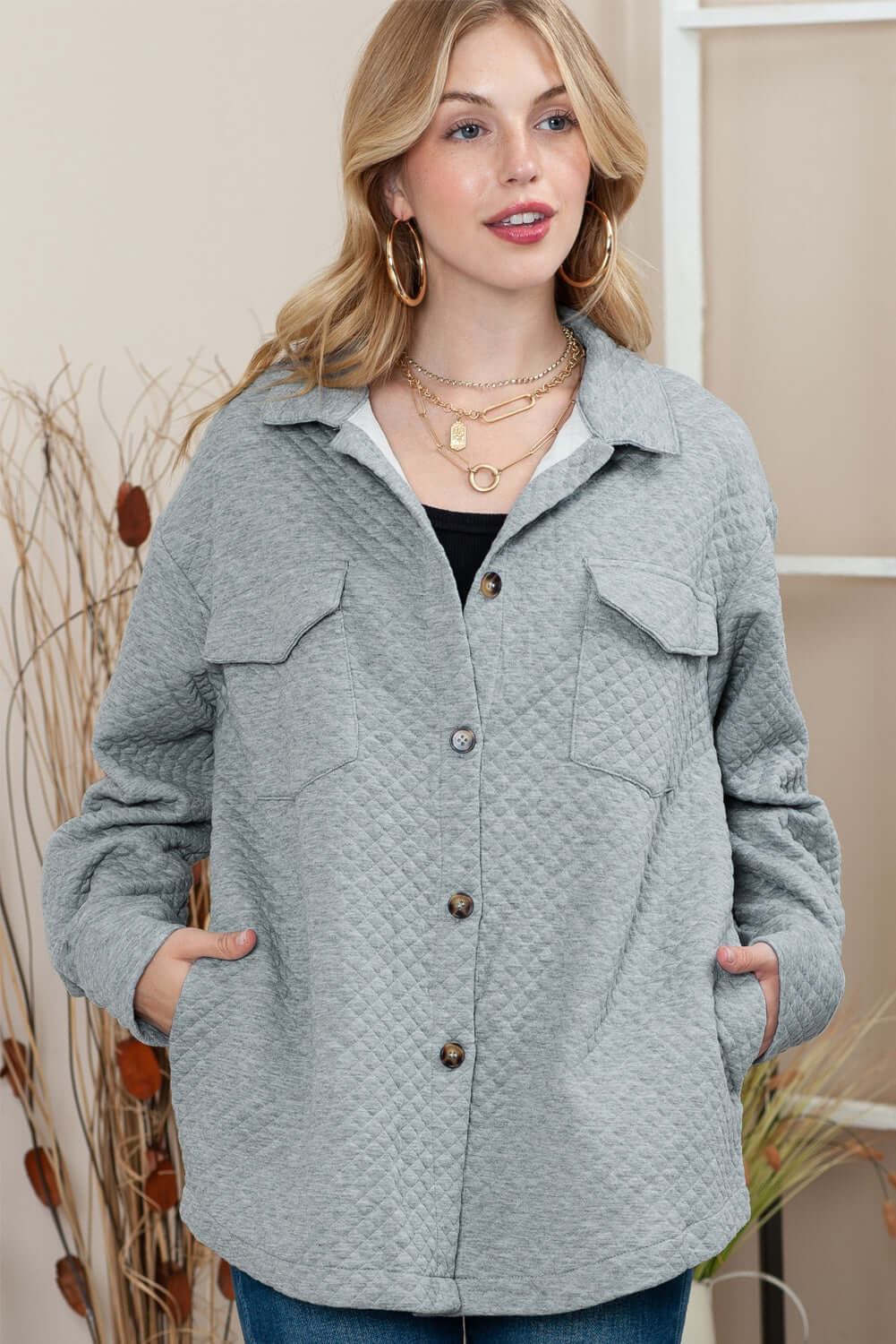 Model layering the jacket over jeans and a knit for a cosy winter look.