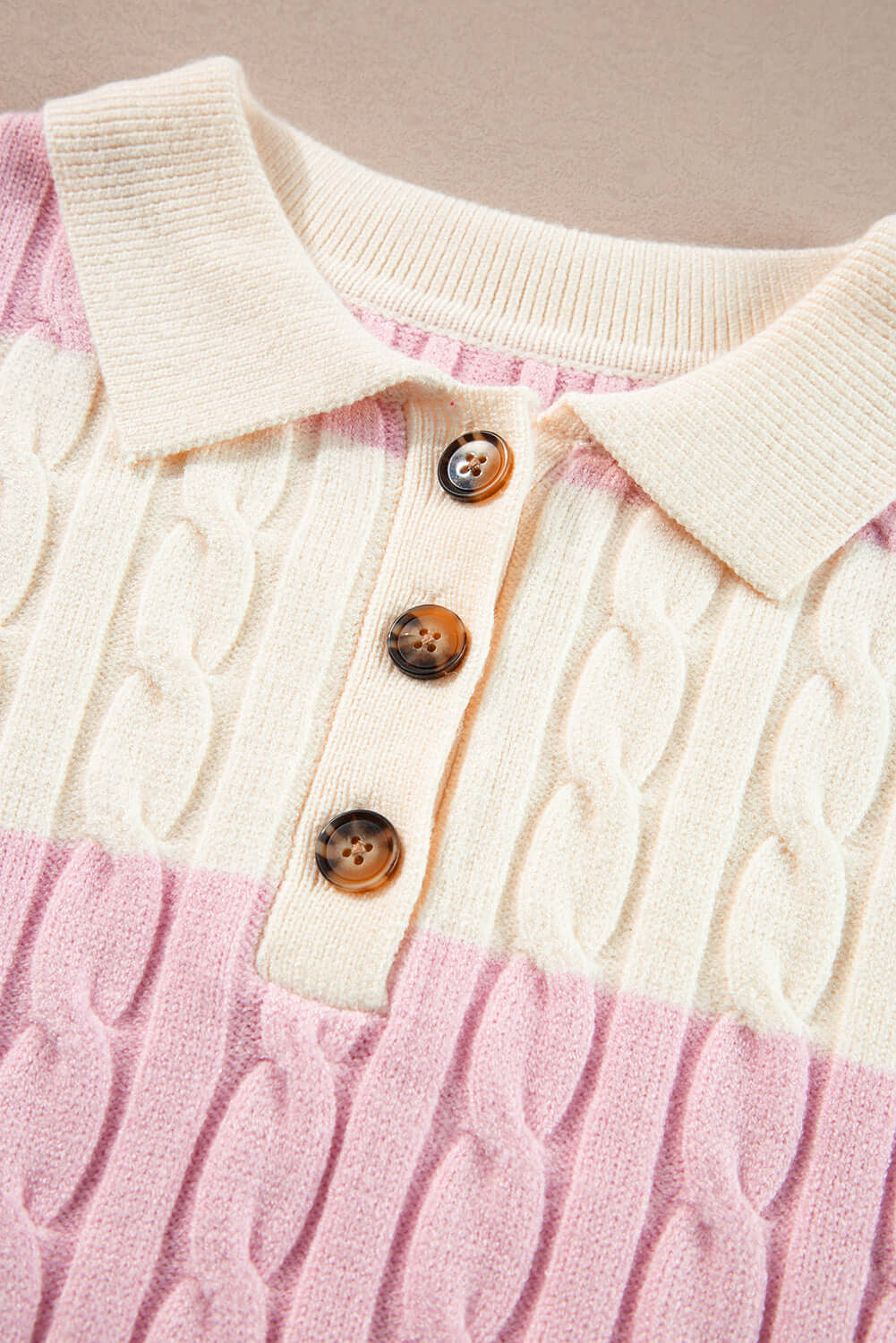 Flat lay of cable knit sweater – perfect layering piece for cooler days. Neckline view.