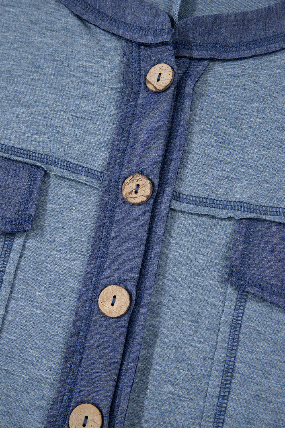 Close-up of a blue garment with wooden buttons
