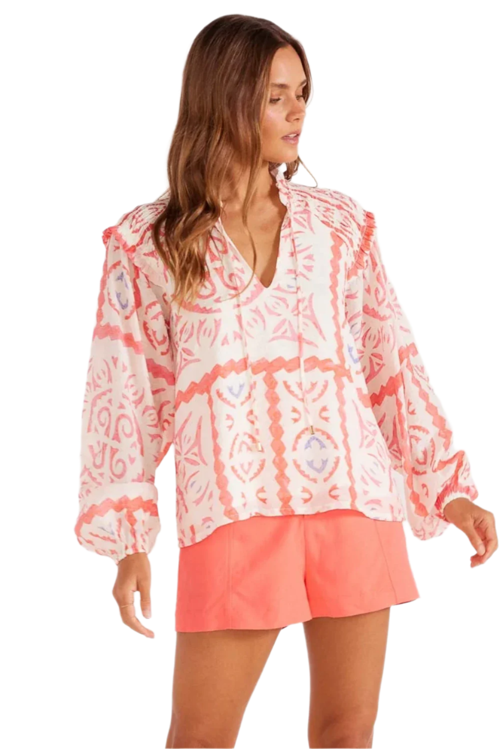 Light orange abstract print with long puff sleeves. Full view.