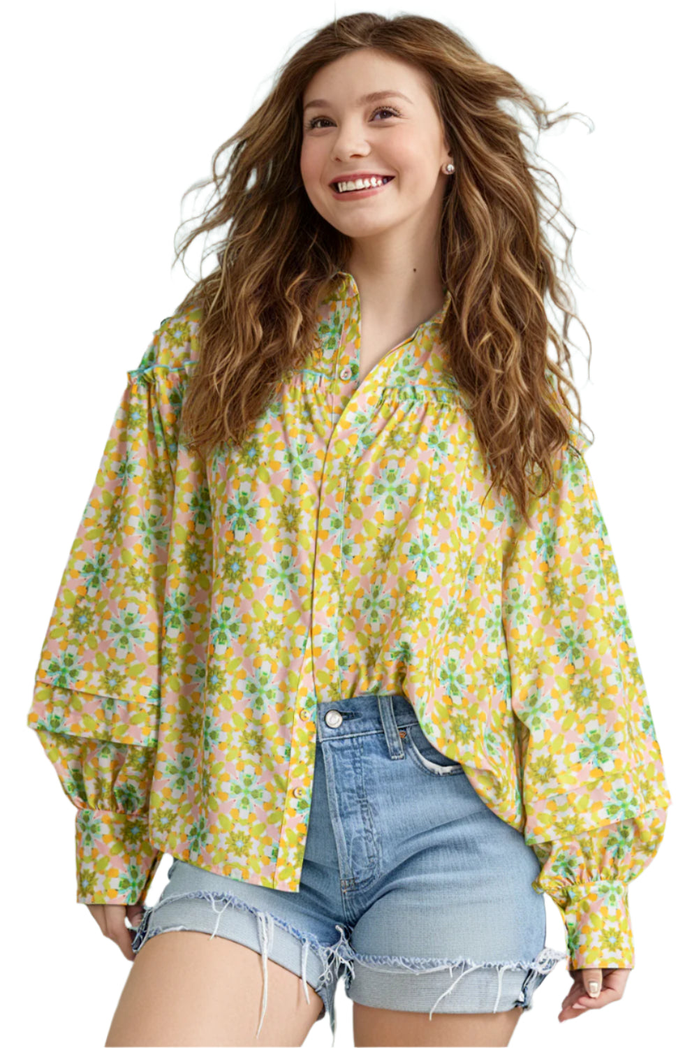 Front view of a green and yellow floral blouse with balloon sleeves paired with denim shorts.