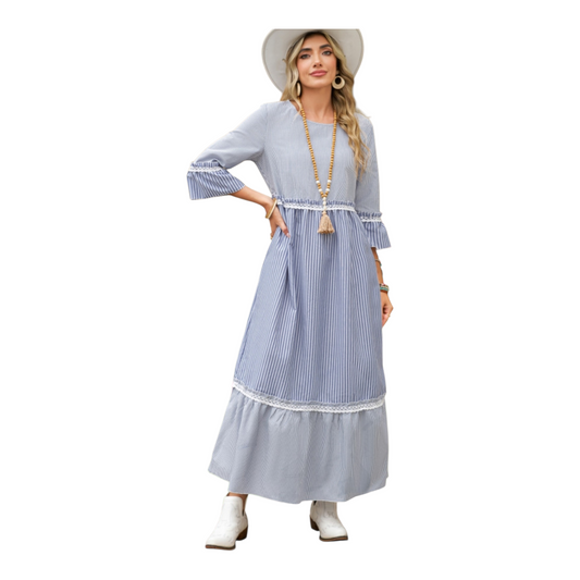 Woman wearing a long blue and white striped dress with a hat on a white background
