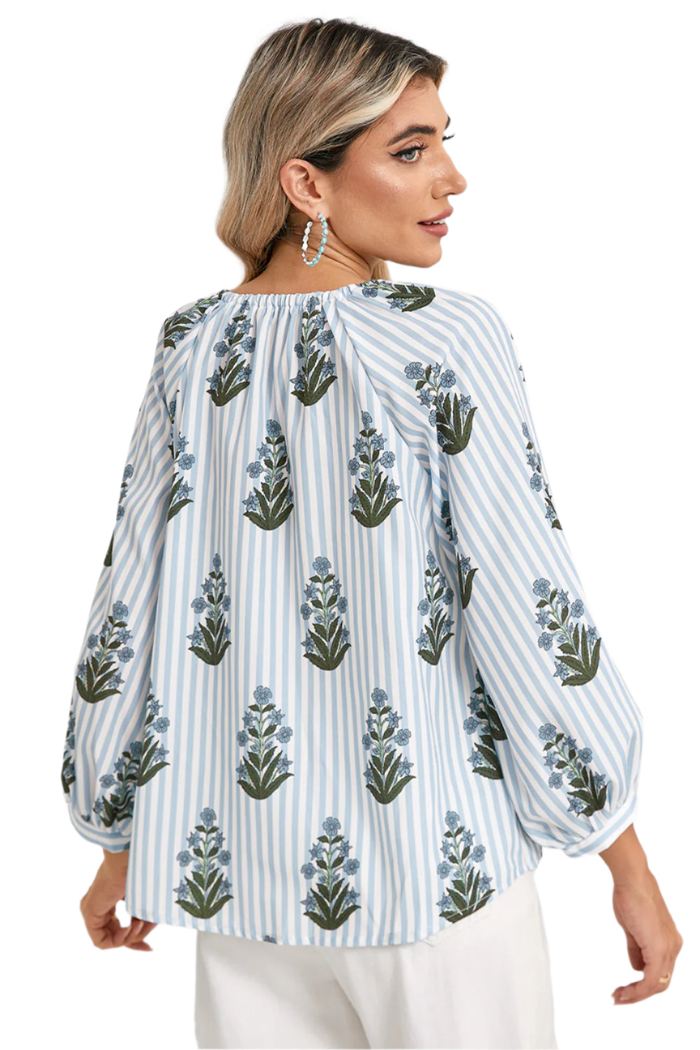 Back view of a blue floral striped blouse with long sleeves, perfect for spring and summer, worn by a model showcasing a boho-chic style.