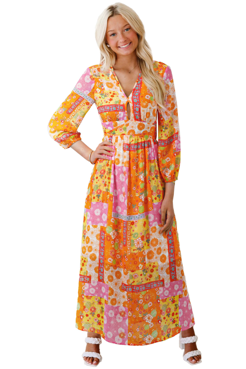 Woman wearing a colorful floral dress on a white background